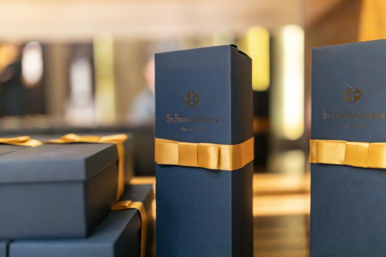 Sophisticated gift boxes with yellow ribbons promoting luxury merchandise.