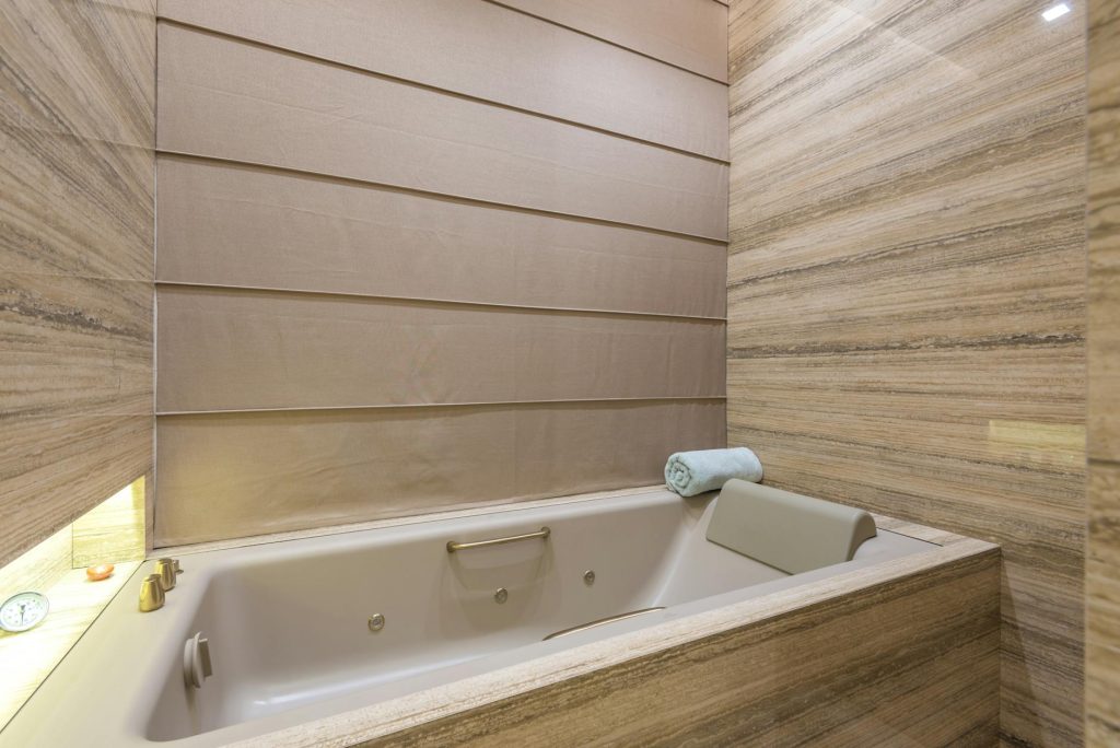 Luxurious modern bathroom interior featuring a marble bathtub and elegant design.