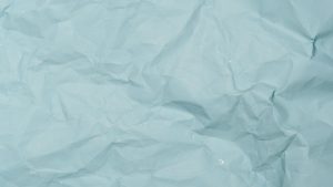 Detailed crumpled blue paper background perfect for design projects needing textured material.