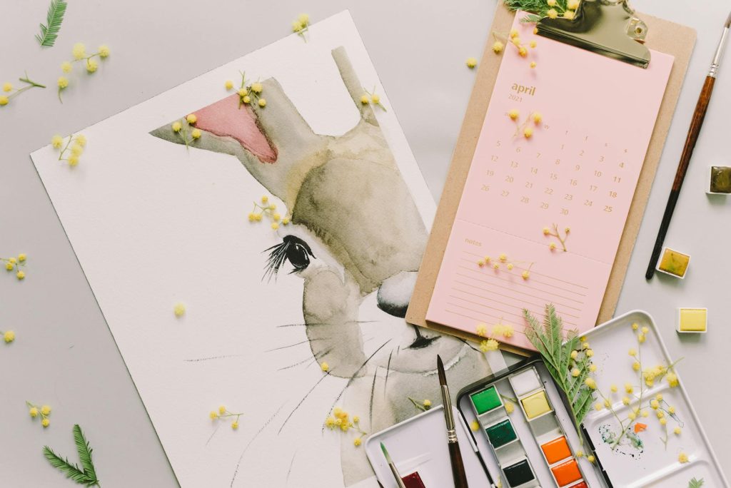 Artistic watercolor painting of a bunny with an April calendar, celebrating spring creativity.