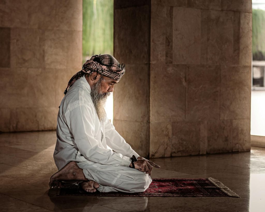 a man praying in a mosque