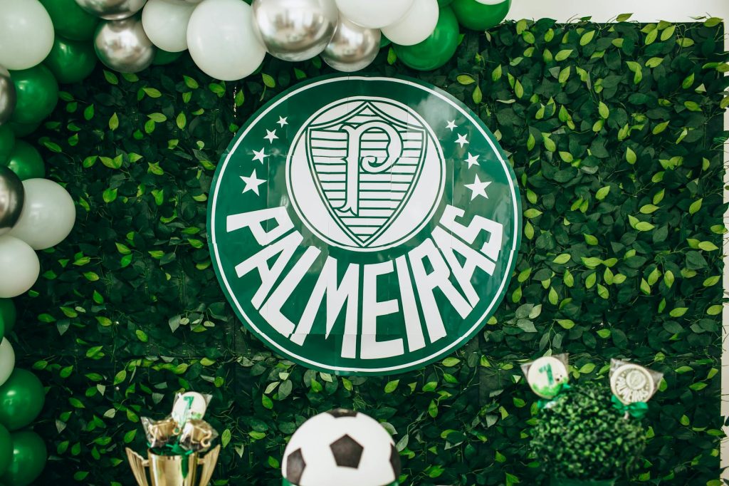 Green and white Palmeiras themed backdrop with balloons and football decorations.