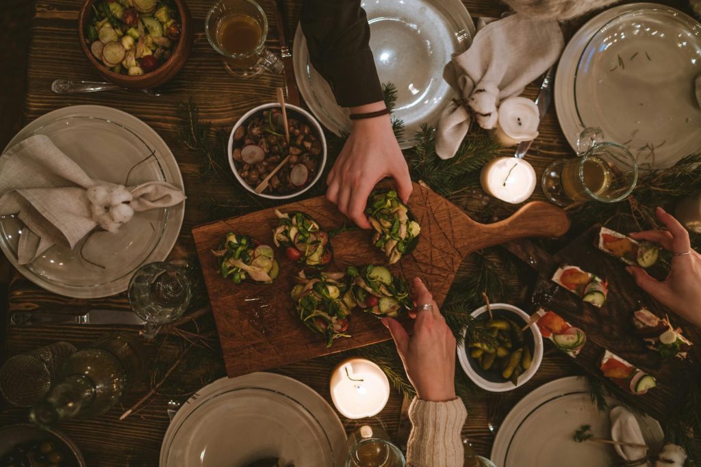 Warm and inviting holiday table with festive decorations and appetizers.