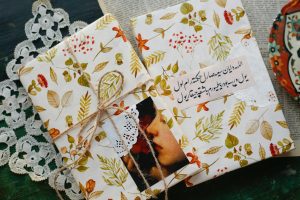 Elegant gifts wrapped in floral paper with lace and Arabic text, perfect for special occasions.