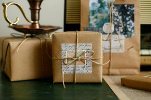 Beautifully wrapped brown paper gifts with twine and handwritten notes, perfect for cozy celebrations.