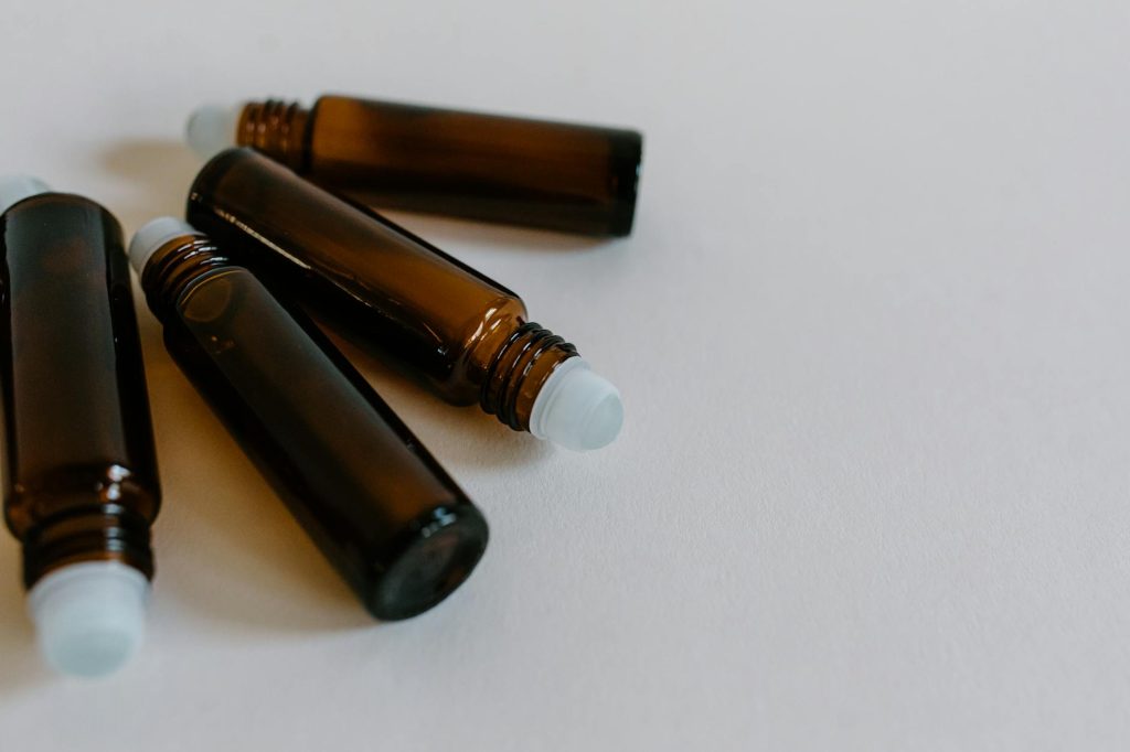 Close-up of brown roller bottles for essential oils, perfect for aromatherapy use.