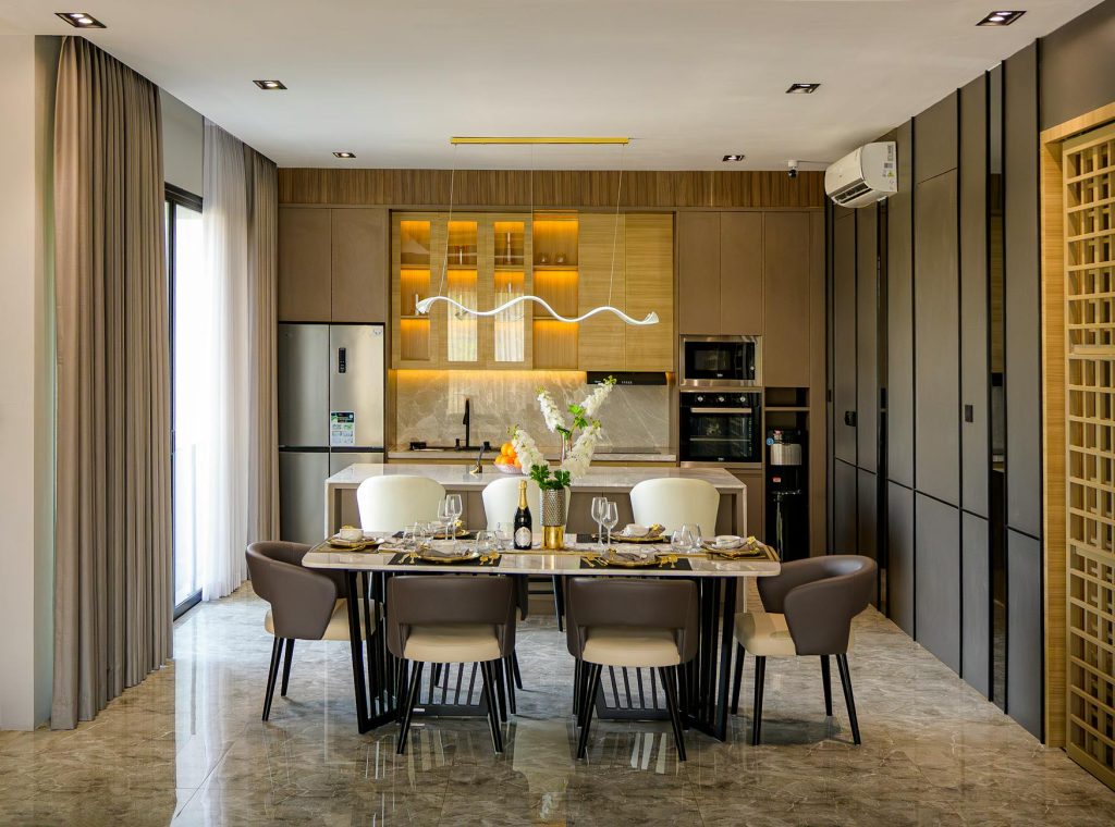 Stylish modern kitchen and dining area in a Jakarta apartment, showcasing luxury interior design.