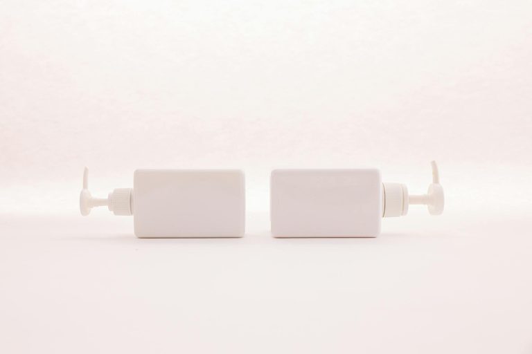 Simple and elegant white pump bottles on a clean white background, perfect for beauty product mockups.