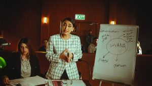 Corporate presentation by a professional woman in a modern Baghdad office.