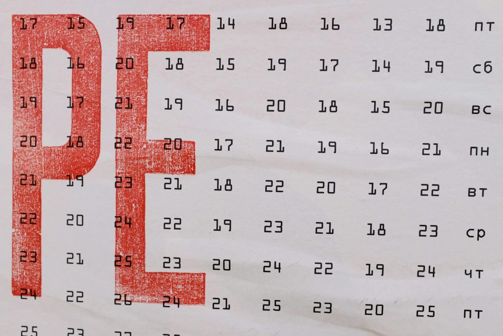 Close-up of a vintage calendar page with red and black Cyrillic text, showing dates and days of the week.