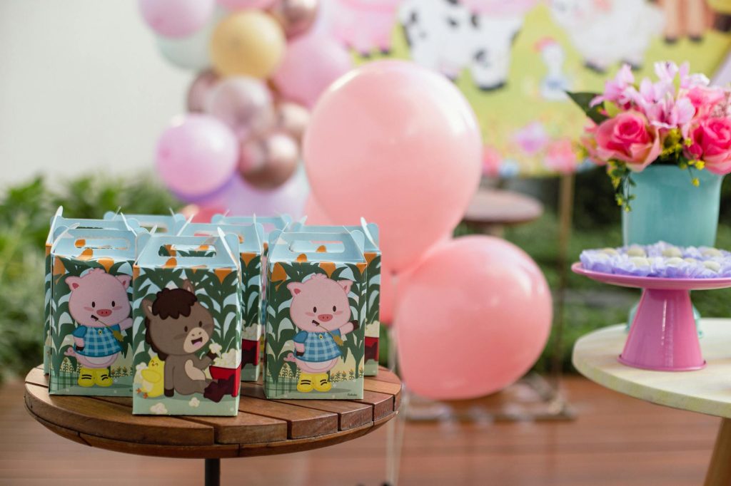 Vibrant birthday party setup with balloons, gift boxes, and flowers.