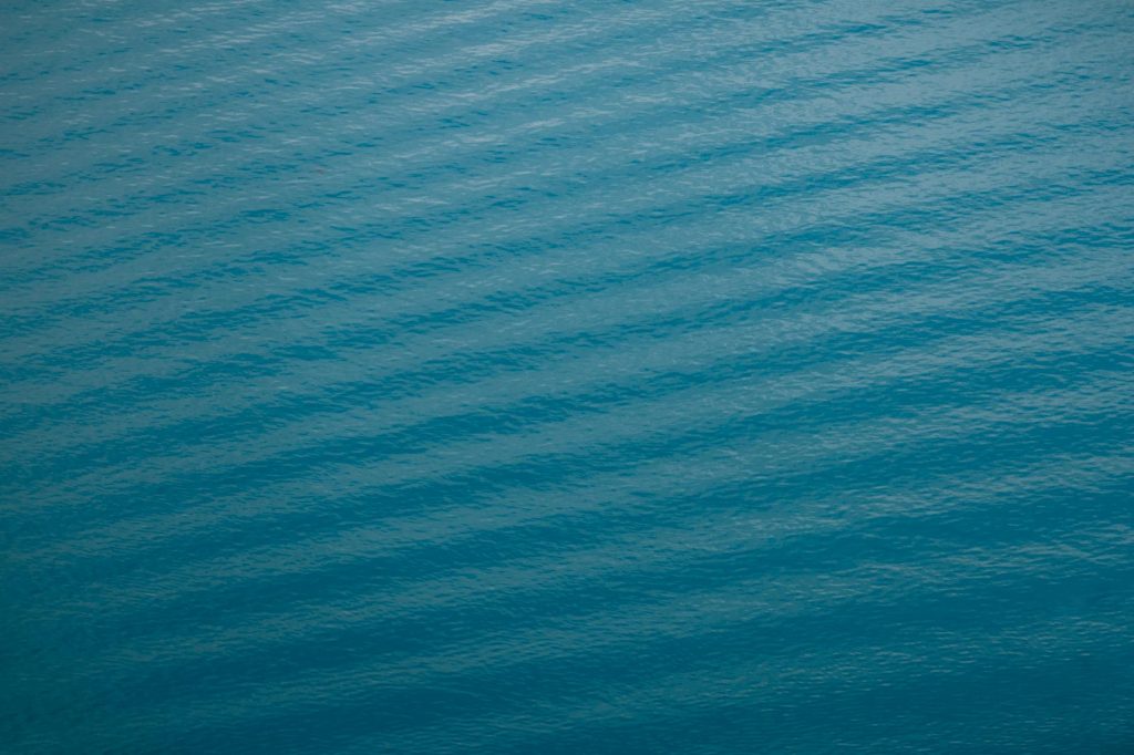 Abstract view of serene blue water ripples, perfect for backgrounds or wallpapers.