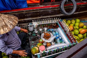 Colorful display of beverages and coconuts at Cần Thơ floating market, Vietnam.