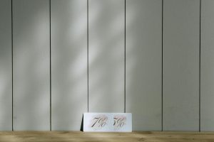 Minimalist discount cards showcasing 7% and 5% set against a wooden backdrop with soft lighting.