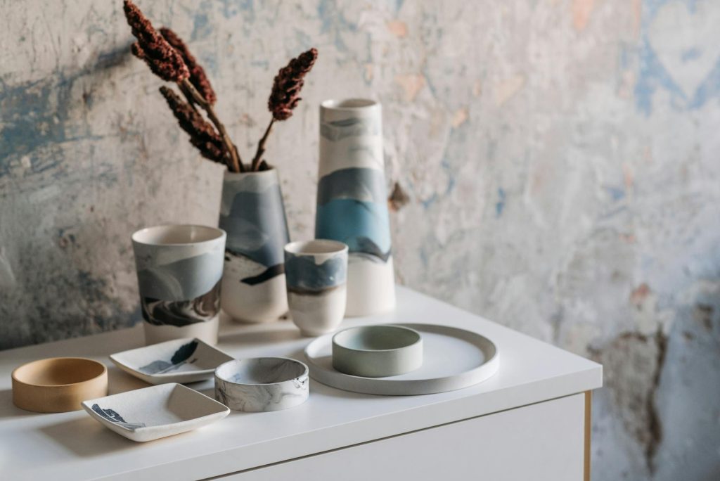 Close-up of beautifully designed ceramic tableware with artistic patterns on a rustic background.