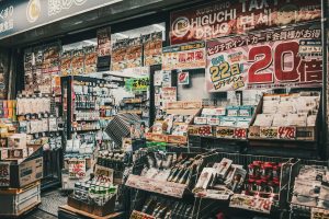 Vibrant display of a drugstore shopfront in Japan, showcasing a variety of products and sale signs.