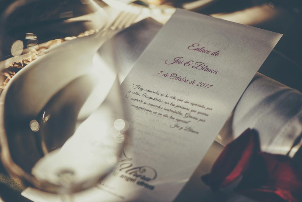 A romantic wedding invitation featuring elegant calligraphy, captured in soft focus for a dreamy feel.