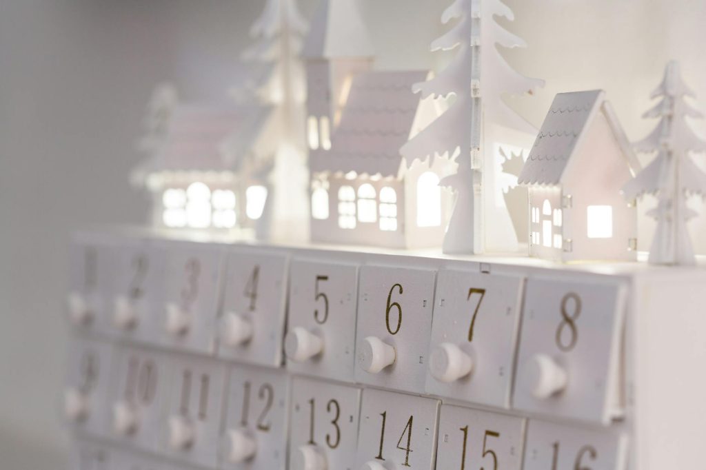 Beautiful minimalist advent calendar with illuminated houses and numbers for winter decor and festive ambiance.