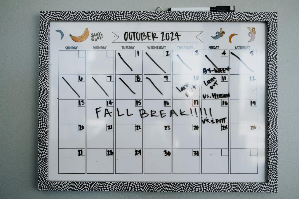 Close-up of a whiteboard calendar for October 2024 featuring a fall break note.