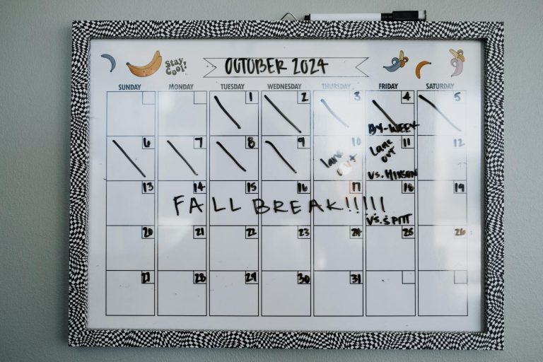 Close-up of a whiteboard calendar for October 2024 featuring a fall break note.