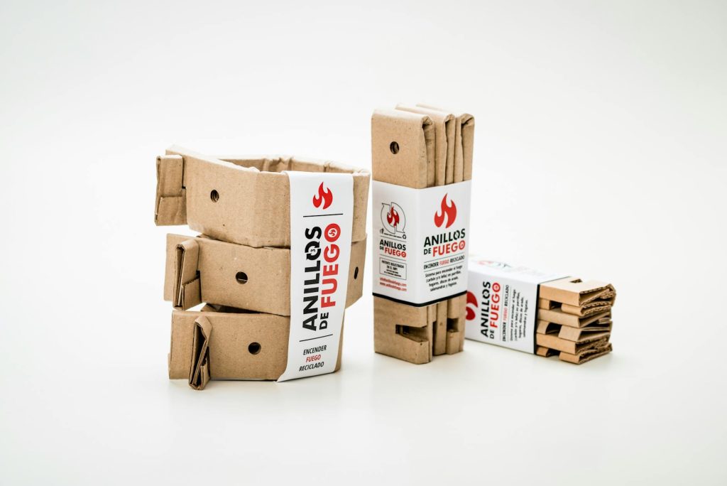 Recyclable cardboard fire starter packs on a white background.