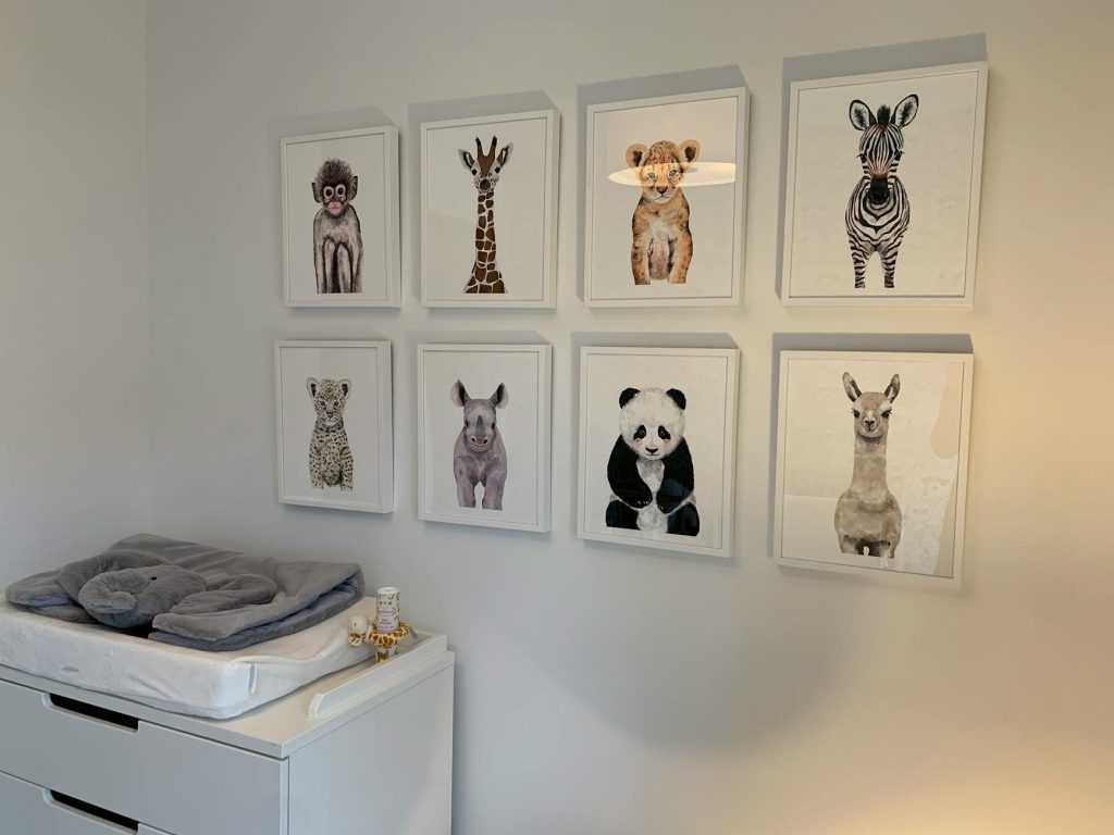 Adorable animal prints adding charm to a minimalist nursery wall decor.