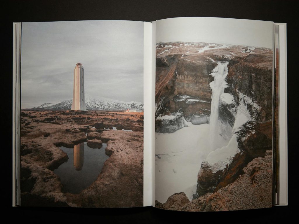 An open book displaying photographs of a lighthouse and a waterfall.