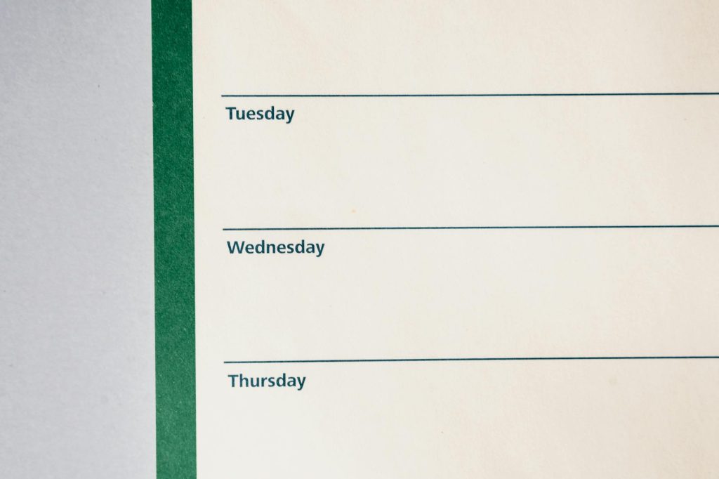 Close-up view of a minimalist weekly planner featuring days of the week.