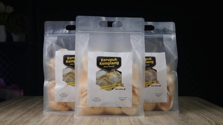 Clear packaging of Kerupuk Kemplang, showcasing crispy Indonesian prawn crackers.