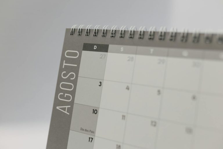 Detailed close-up of a spiral-bound calendar displaying the month of August.
