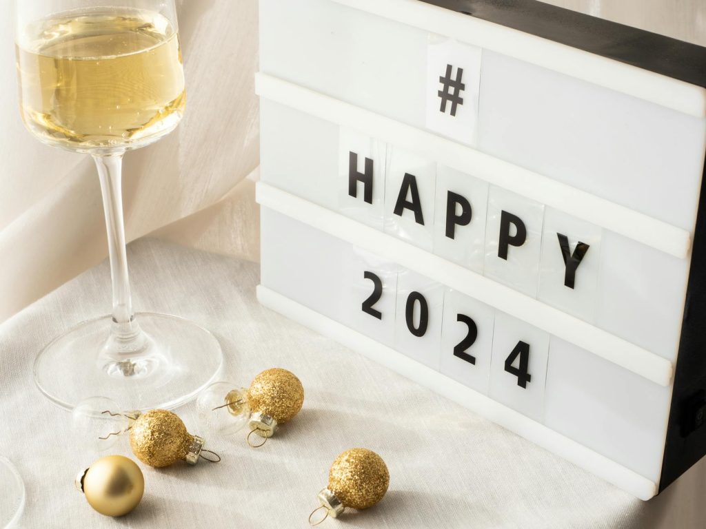 Elegant setting with champagne and decor for a festive 2024 New Year celebration.