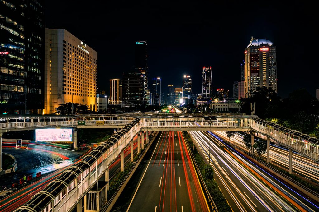 Long exposure night shot capturing Jakarta's vibrant skyline and bustling traffic.