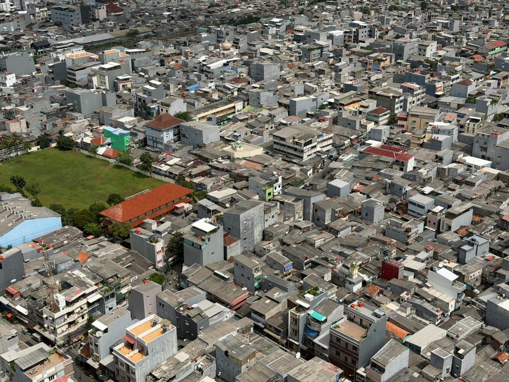 Aerial photograph showcasing the densely packed urban landscape of Jakarta, Indonesia.