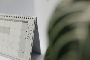 A close-up shot of a desk calendar open on March, with a soft, minimalistic background.