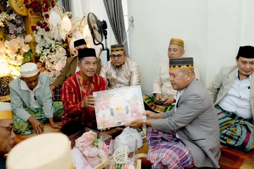 Participants engage in a traditional marriage ceremony in South East Sulawesi, displaying local cultural attire.
