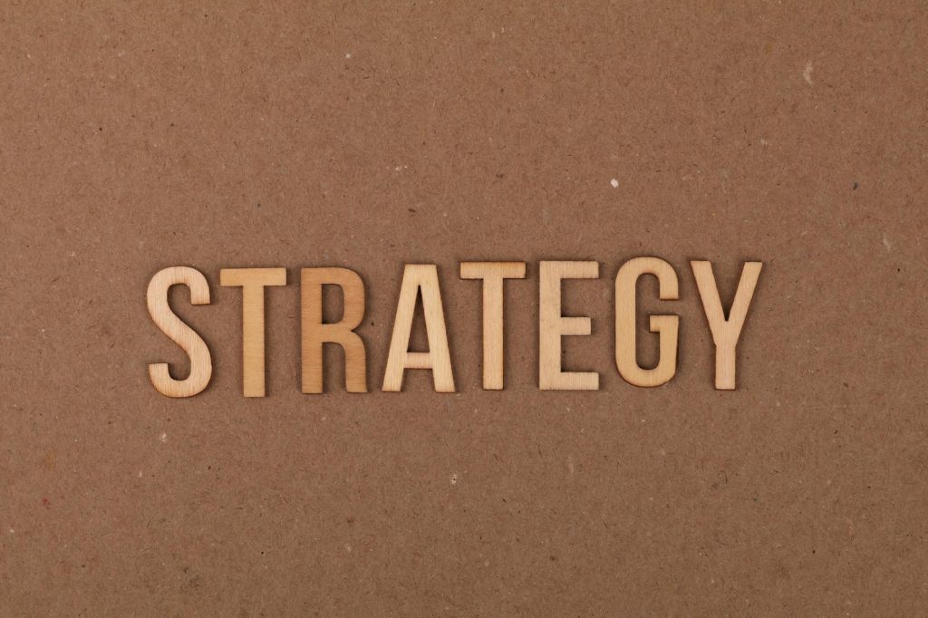 Wooden letters spelling 'Strategy' on a cardboard background, perfect for business concepts.
