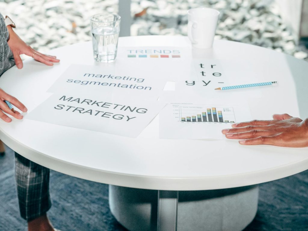 Two professionals collaborate on marketing strategy and segmentation at a round table.
