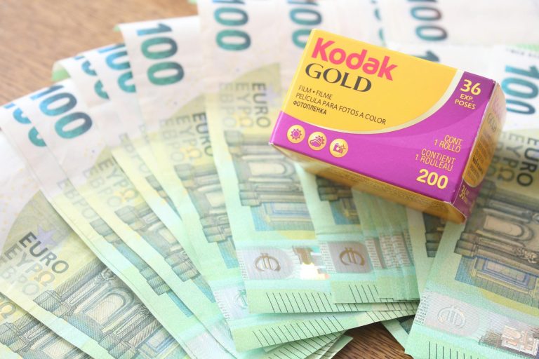 Kodak Gold 200 film box placed atop 100 euro banknotes in a vibrant image.