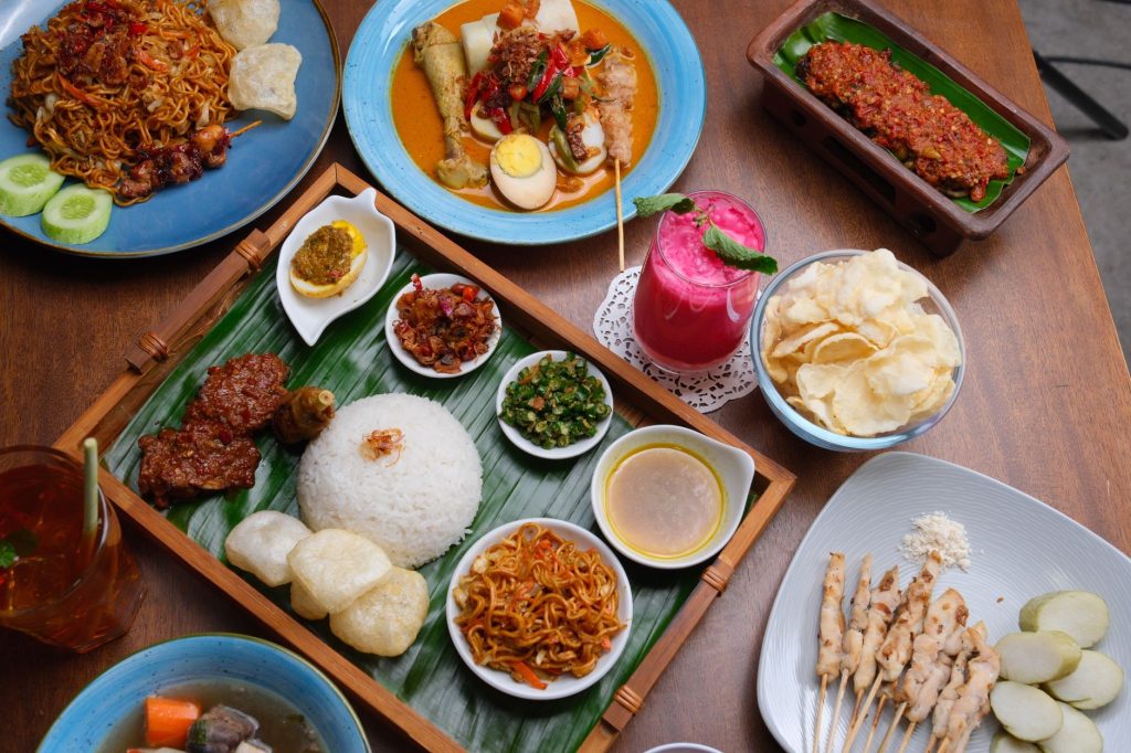 A vibrant display of authentic Indonesian cuisine featuring nasi goreng and satay.