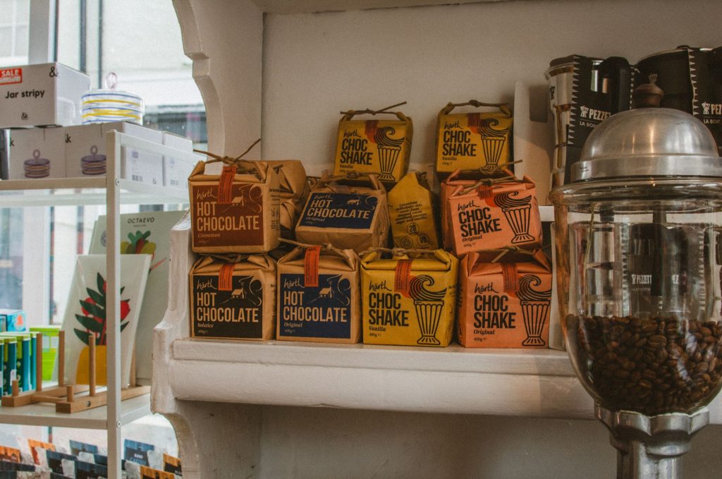 Charming coffee shop in Wales featuring gourmet hot chocolate packages on display. Perfect for cozy evenings.