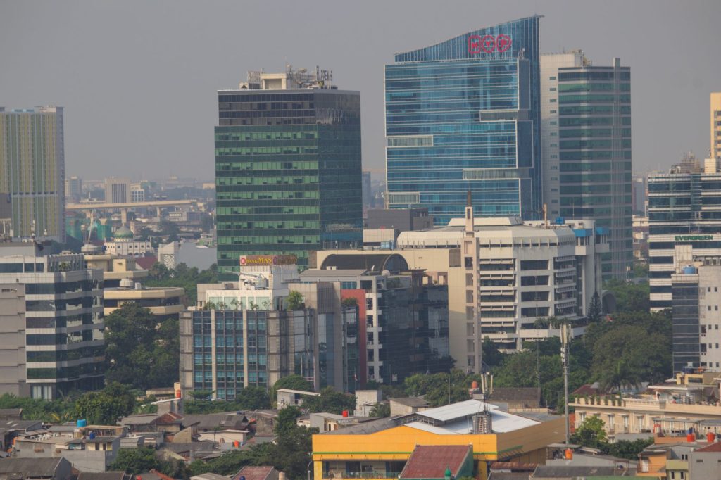 Aerial view of Jakarta's urban skyline showcasing modern skyscrapers and bustling city life.